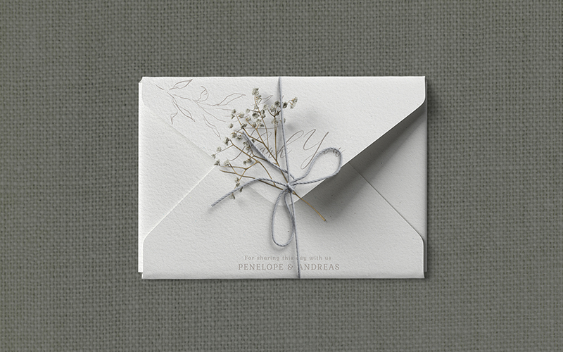 Dried Flower tied with thread around the wedding envelope.