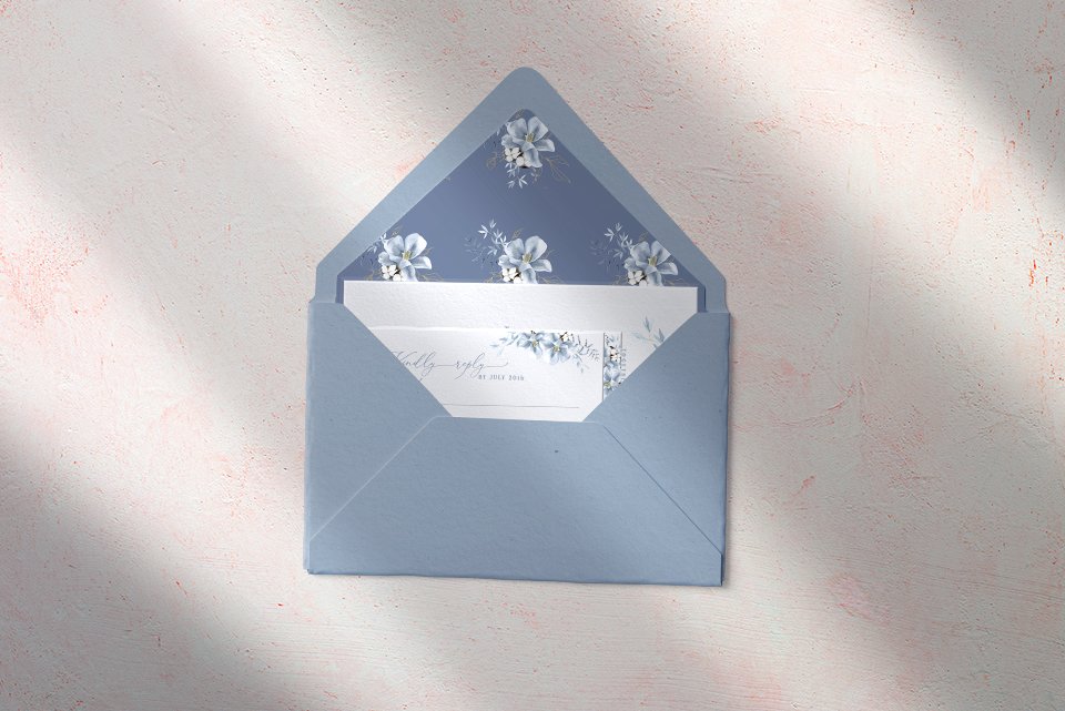 Wedding Invitation Cards being placed inside the wedding envelope.