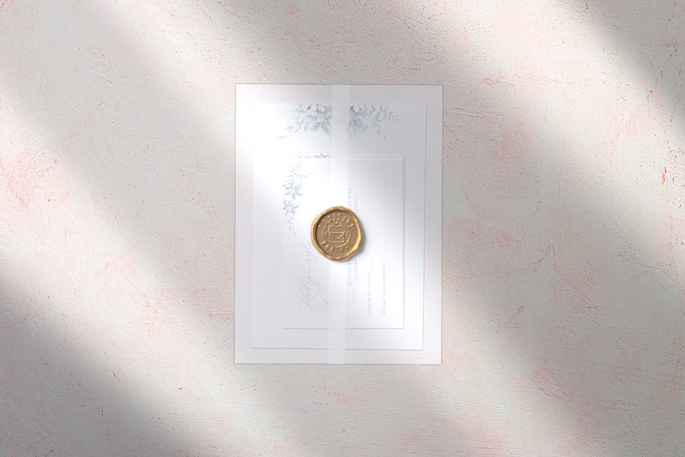 Wedding Cards wrapped in vellum jacket affixed with gold wax seal.